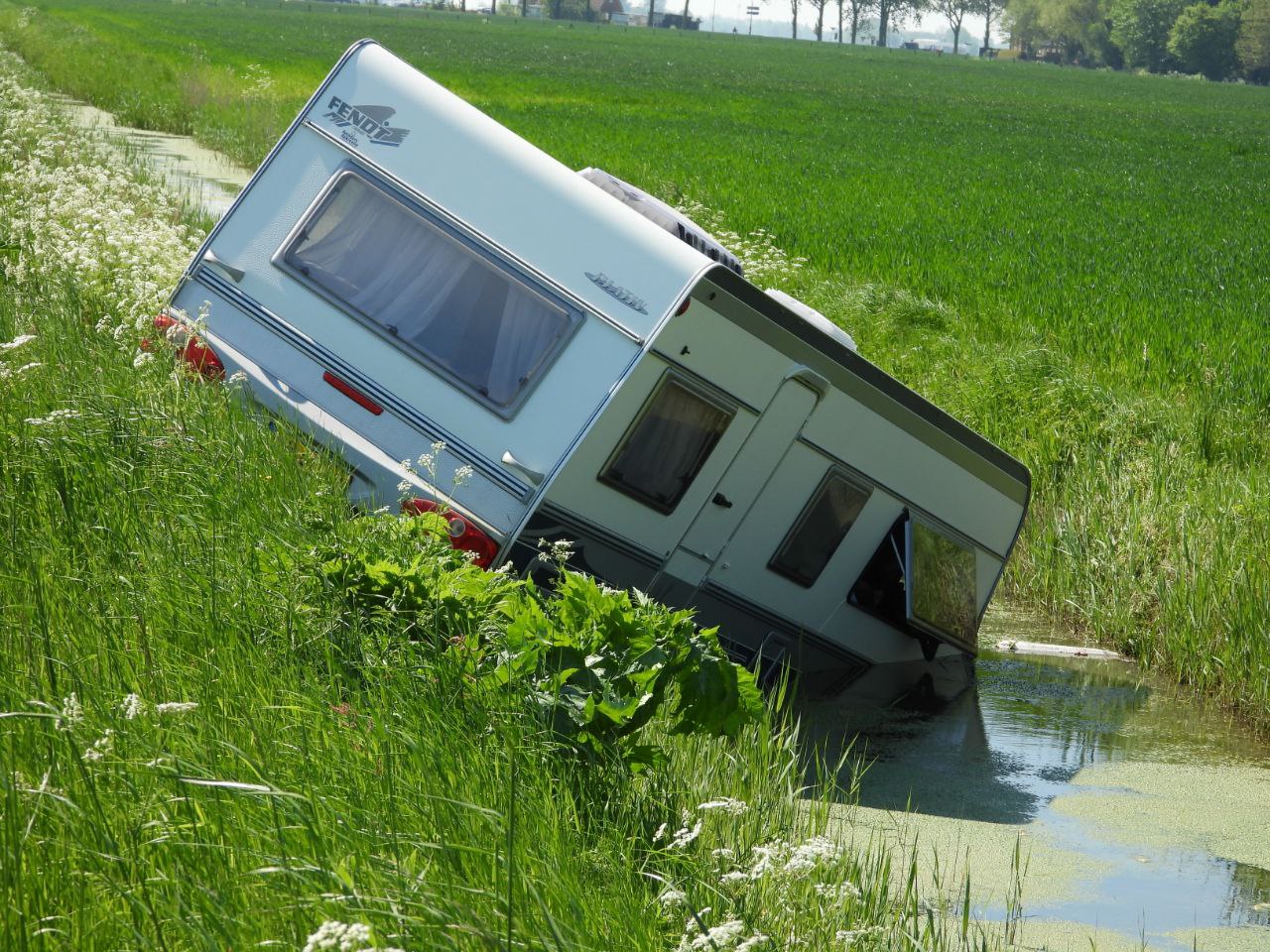 Caravan schiet van trekhaak en belandt in de sloot