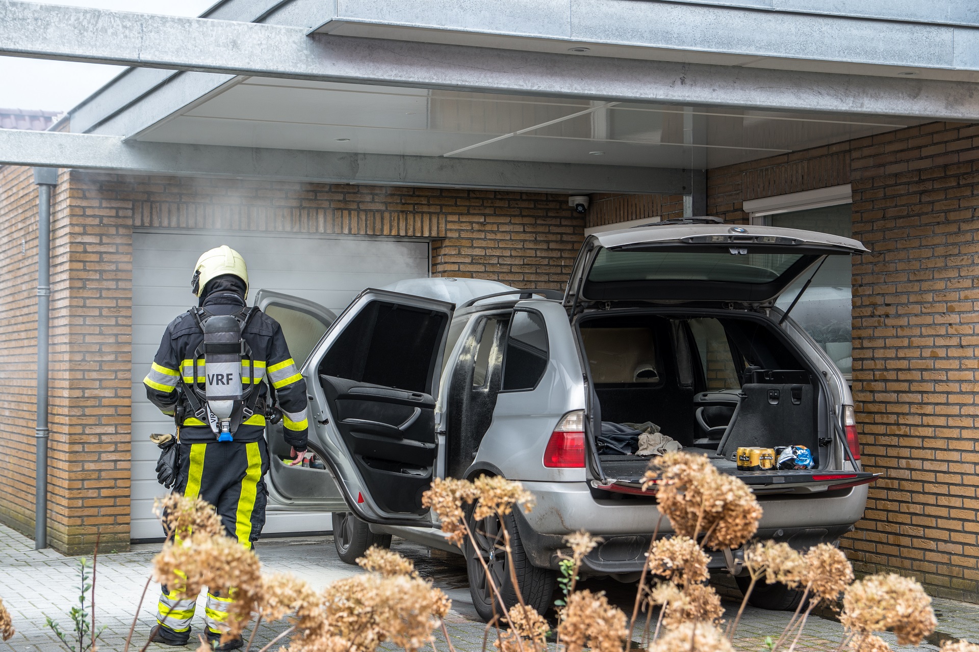 Auto vat vlam onder carport van woning