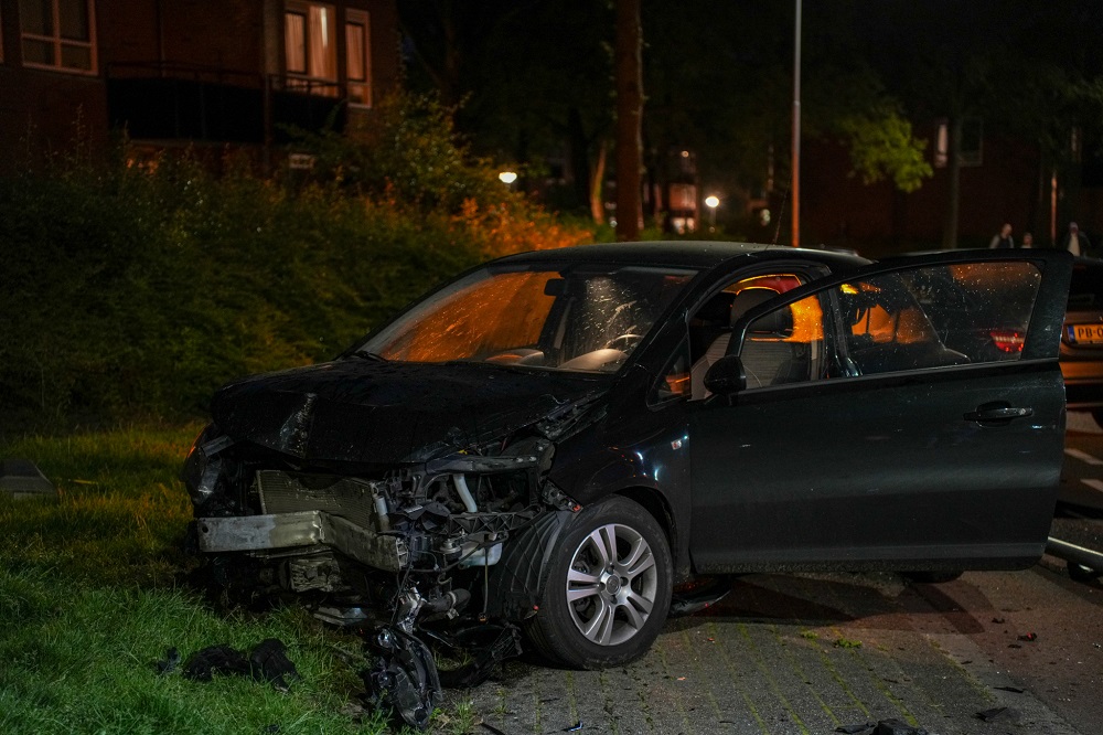 Automobiliste rijdt in bocht lantaarnpaal uit de grond