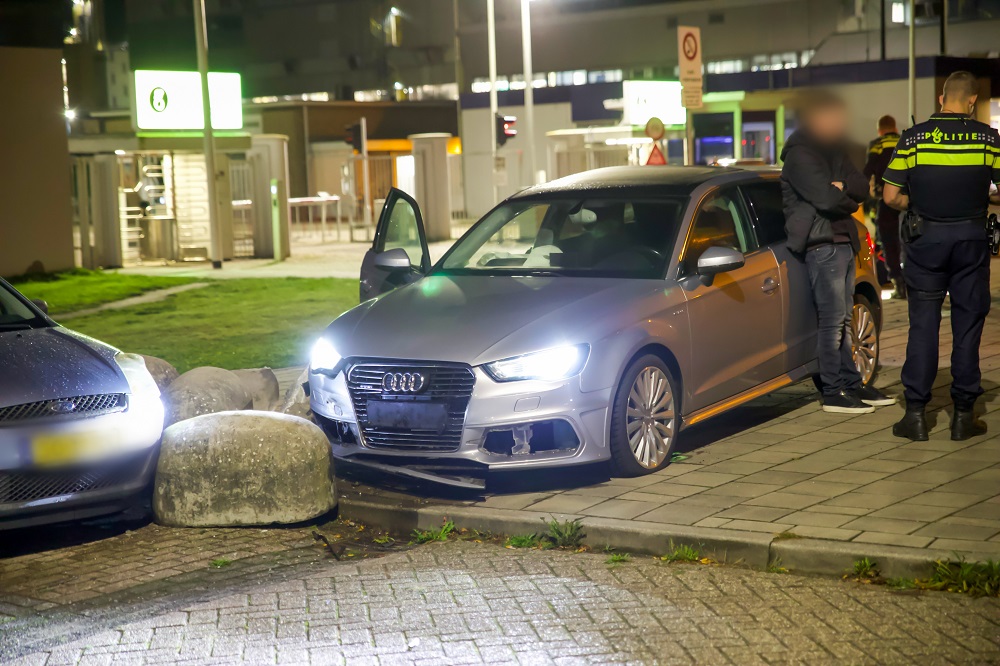 Bijrijder gewond na botsing tegen betonblok, bestuurder mogelijk onder invloed