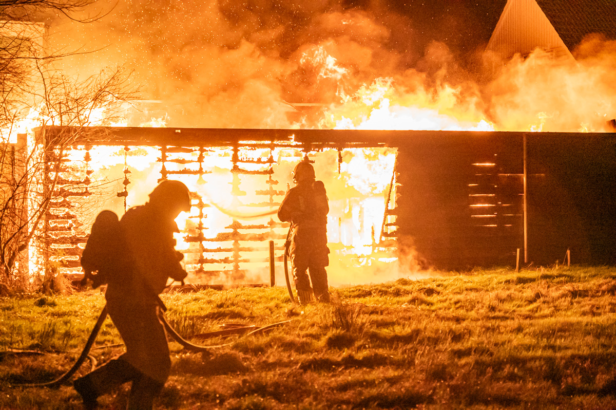 Uitslaande brand verwoest schuur en schutting achter woning