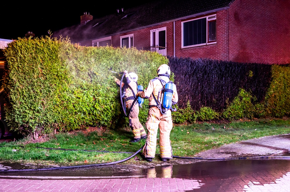 Coniferenhaag vliegt in brand, mogelijk brandstichting