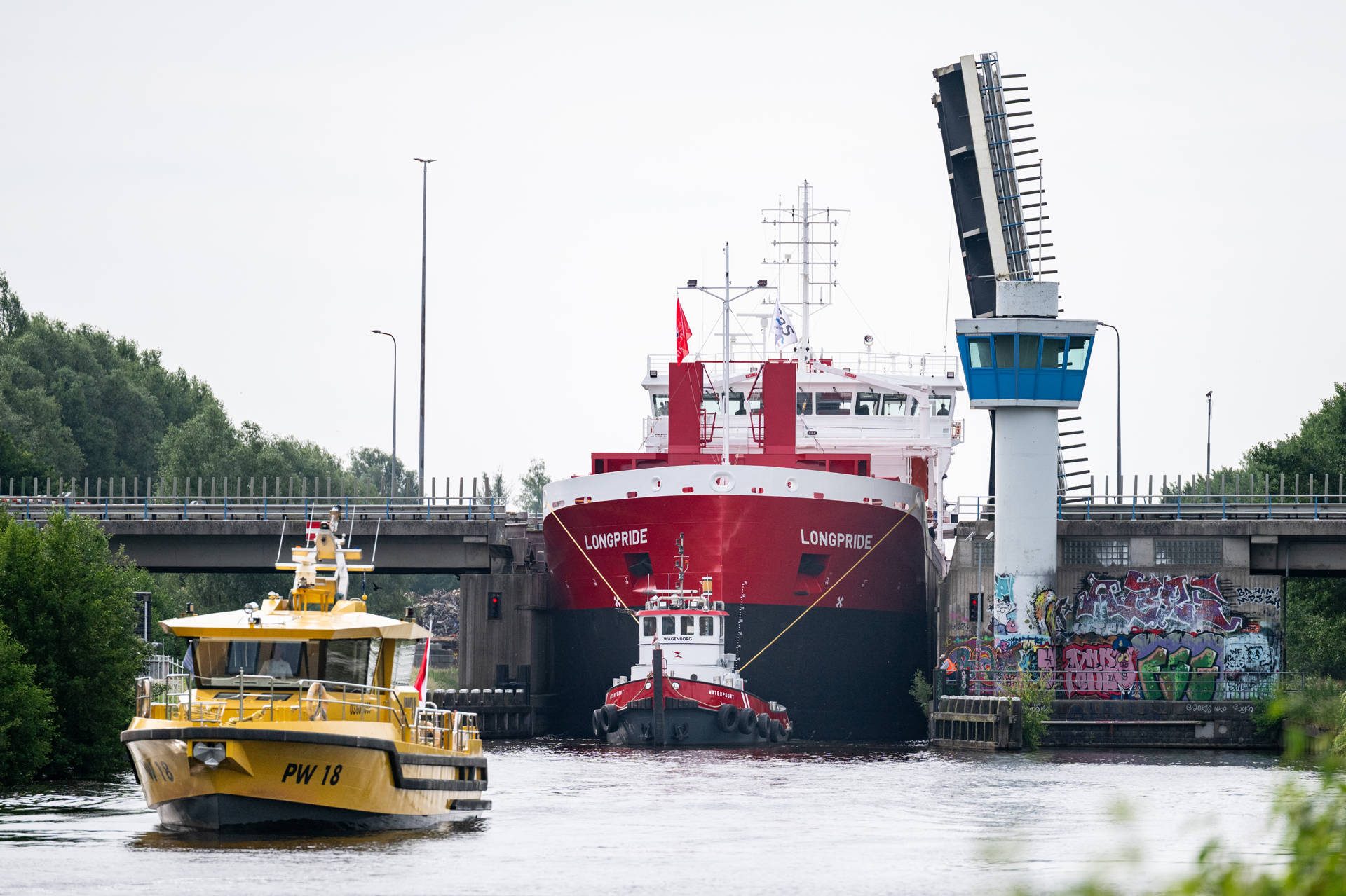 Enorme file door langzaam varend vrachtschip dat brug meer dan kwartier blokkeerde
