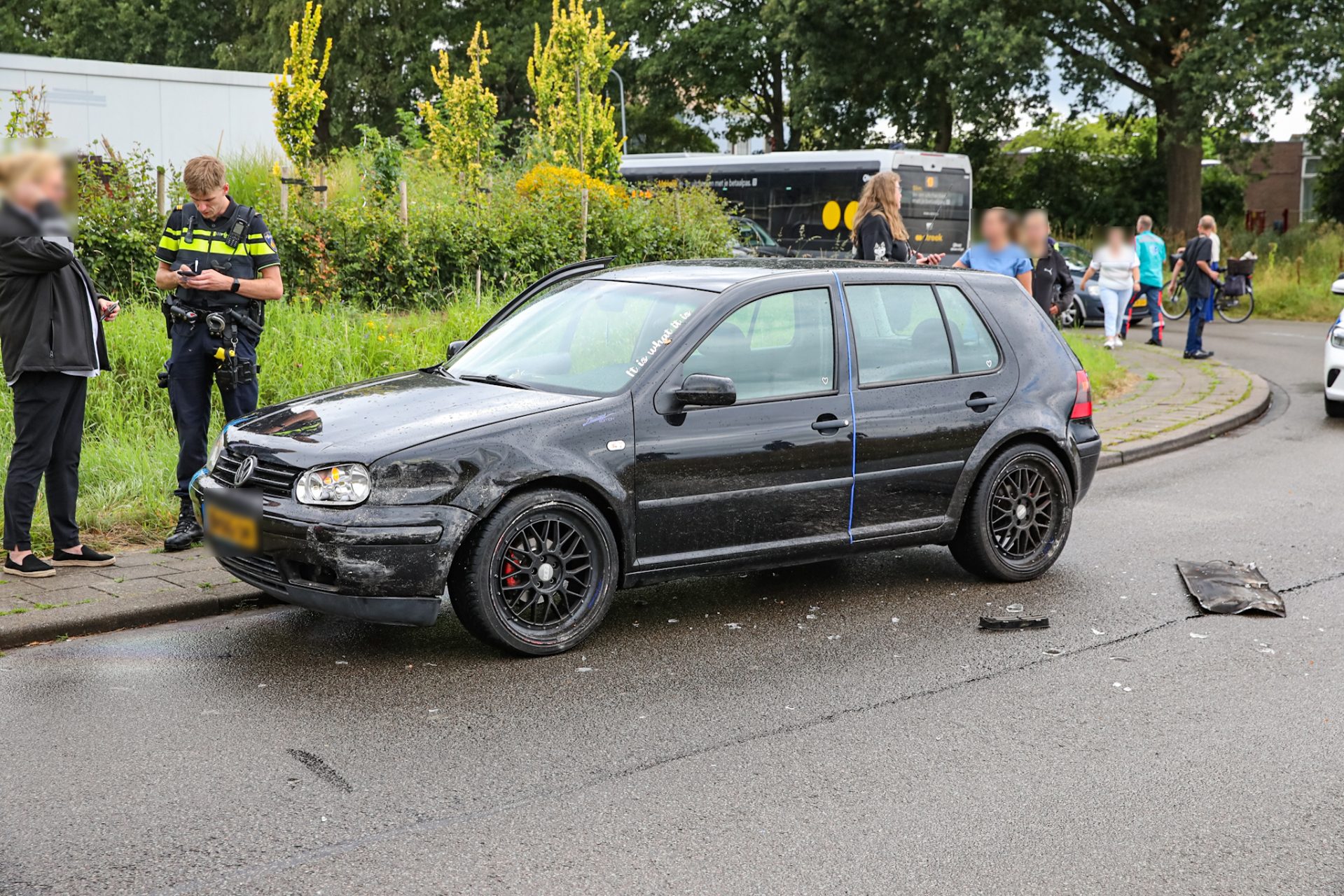 Auto en lijnbus botsen in bocht