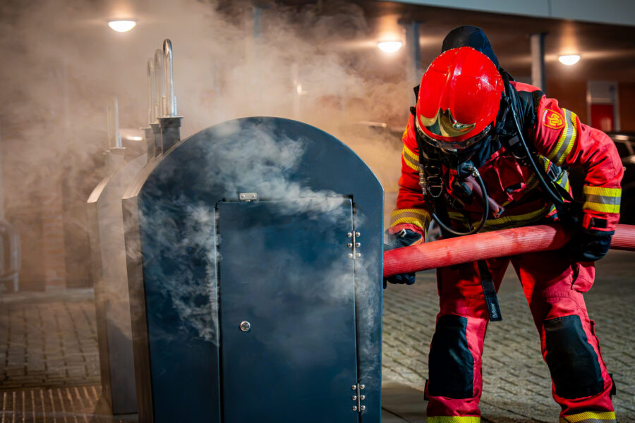 Omstanders krijgen nat pak tijdens blussen containerbrand
